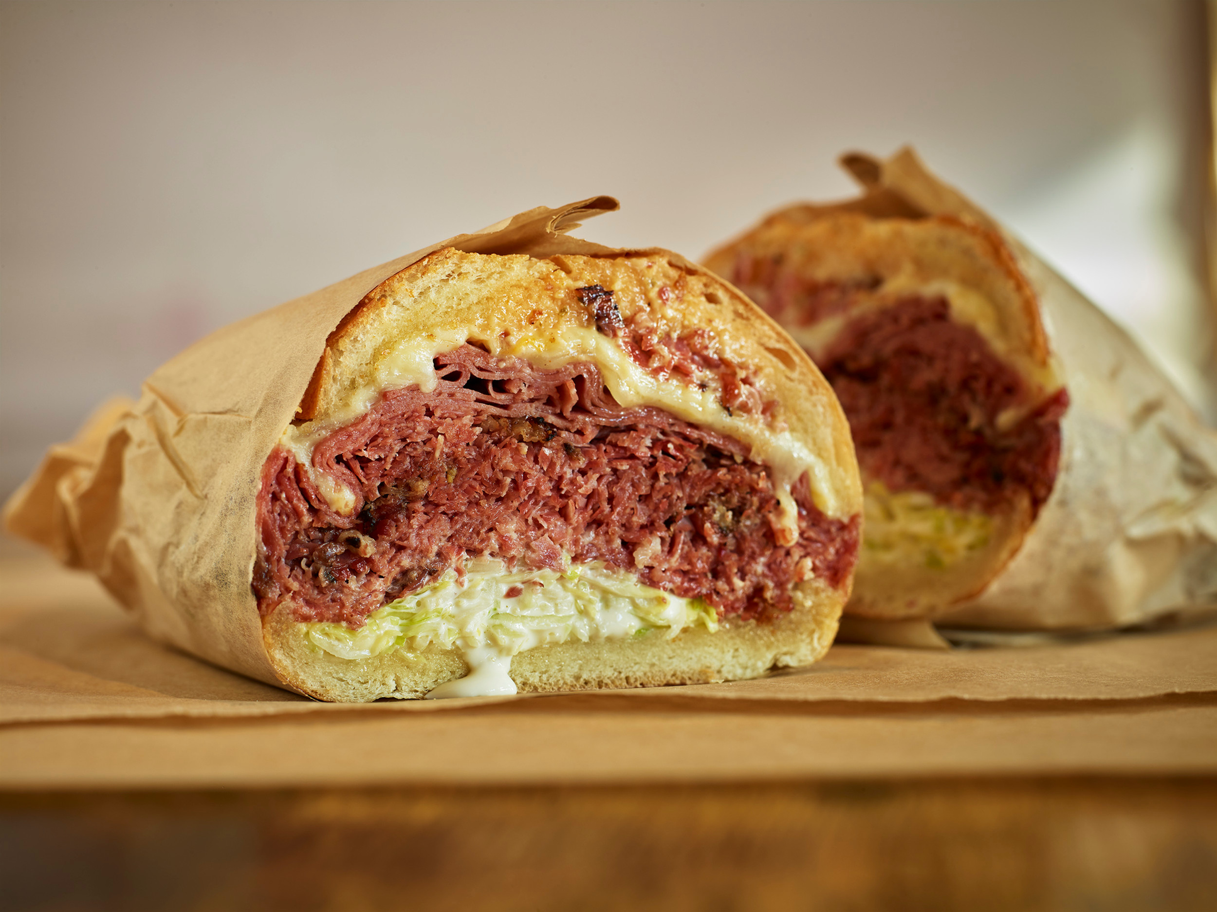 Two halves of a stacked deli sandwich from Deli Board.