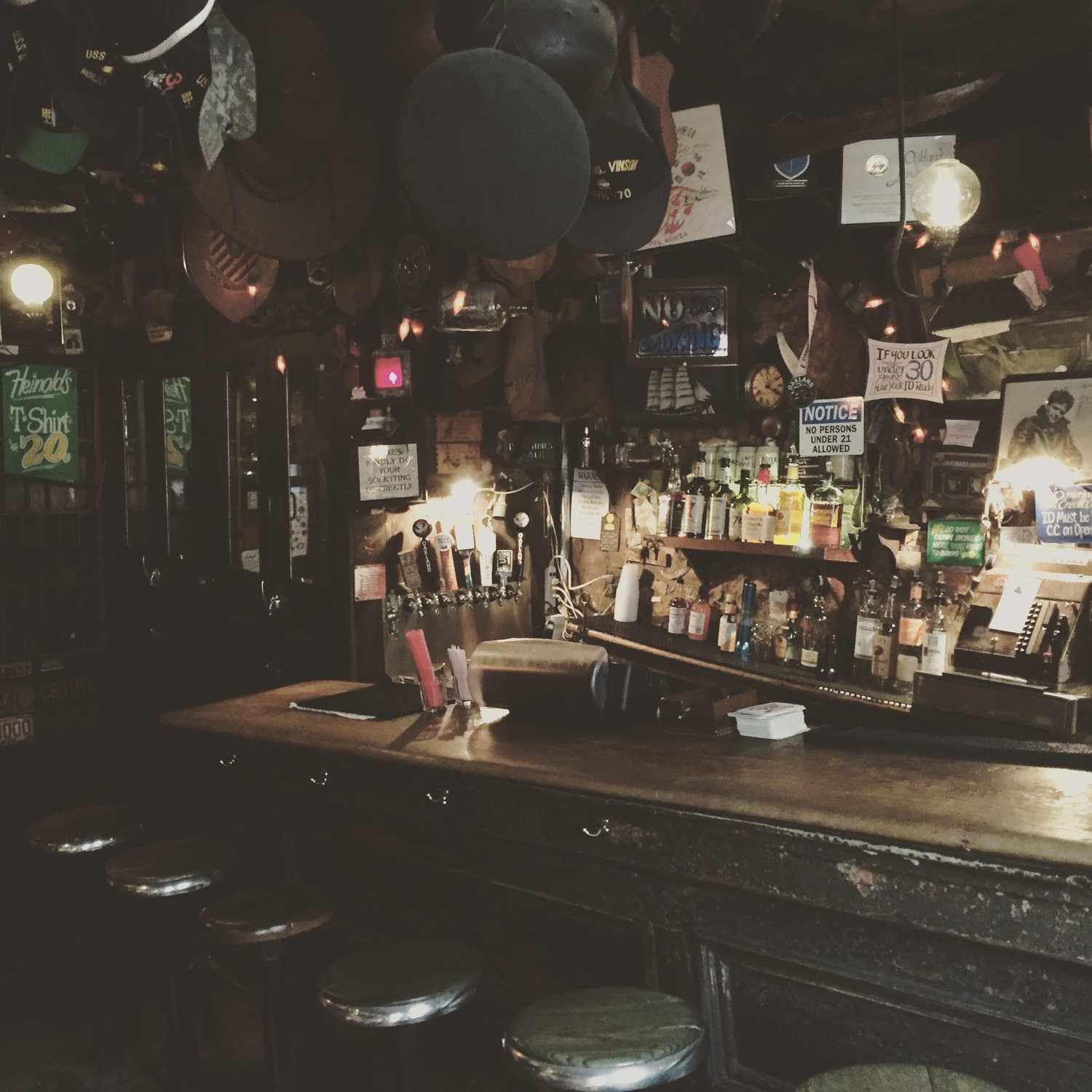 The wooden bar, hanging hats and memorabilia inside Heinold’s First & Last Chance Saloon.