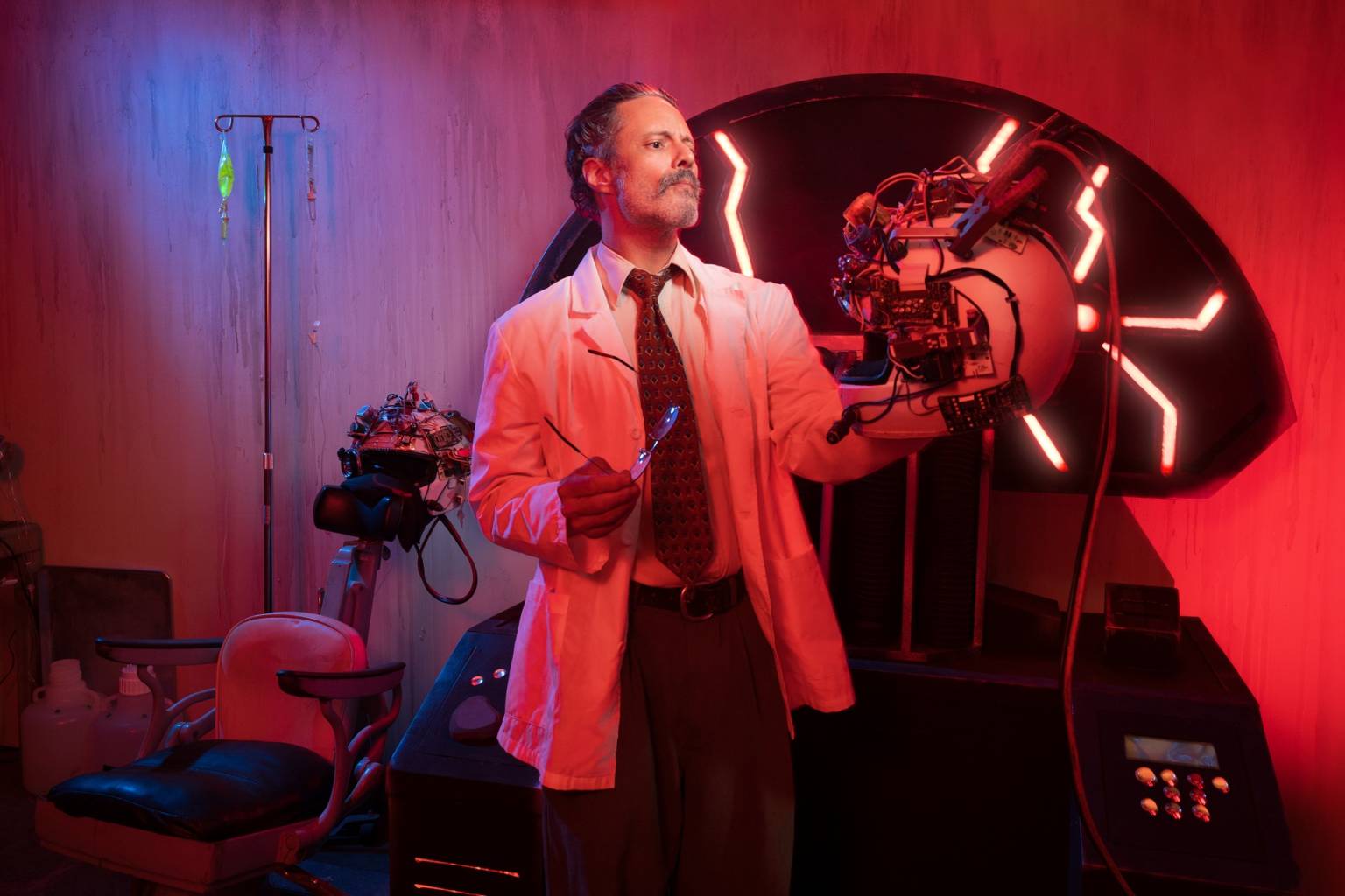 A costumed performer in a dramatic red-lit laboratory set at Terror Vault in the San Francisco Mint.